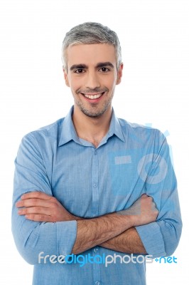 Young Smiling Guy, Arms Crossed Stock Photo