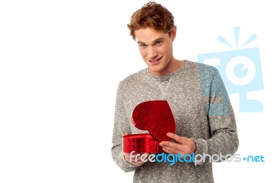 Young Smiling Guy Holding Gift Box Stock Photo