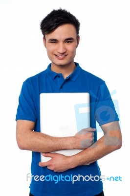 Young Smiling Guy Holding Laptop Stock Photo