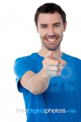 Young Smiling Guy Pointing You Out Stock Photo