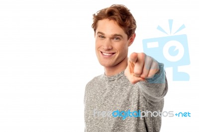 Young Smiling Guy Pointing You Out Stock Photo