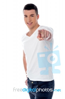 Young Smiling Guy Pointing You Out Stock Photo