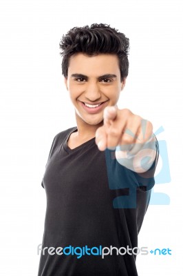 Young Smiling Guy Pointing You Out Stock Photo