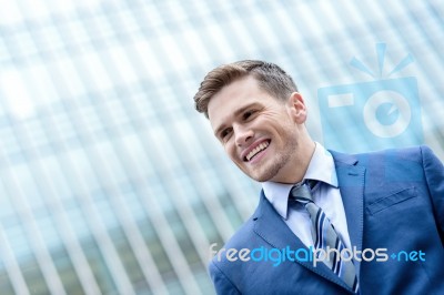 Young Smiling Man On Modern Building Background Stock Photo