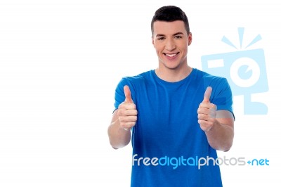 Young Smiling Man Showing Thumbs Up Stock Photo