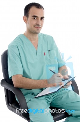 Young Surgeon sitting On Chair Stock Photo