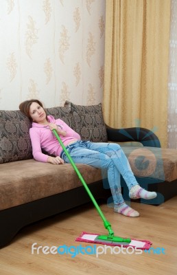 Young Tired Woman Sitting On The Couch Stock Photo