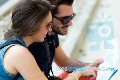 Young Tourist Couple In Town Holding A Map Stock Photo