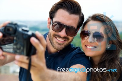 Young Tourist Couple Taking Photo Of Themselves Stock Photo