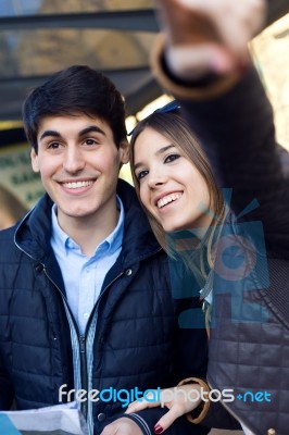 Young Tourist Couple Use Their Map And Pointing Where They Want Stock Photo