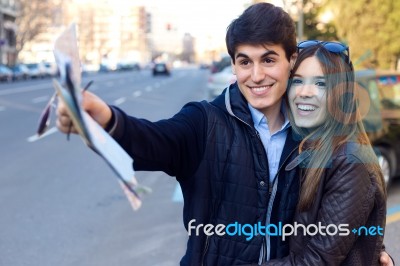 Young Tourist Couple Use Their Map And Pointing Where They Want Stock Photo