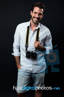 Young Tourist Man With Vintage Photo Camera. Isolated On Black Stock Photo