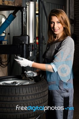 Young Trainee Changing  Car Tyre Stock Photo