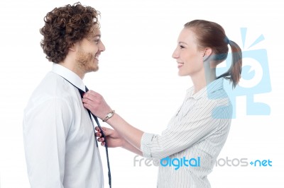 Young Woman Adjusting Her Husband's Tie Stock Photo