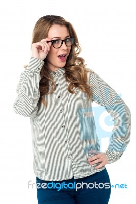 Young Woman Adjusting Her Spectacles Stock Photo