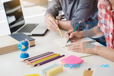 Young Woman And Man Studying For A Test/ An Exam. Tutor Books Wi… Stock Photo