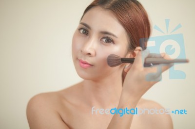 Young Woman Applying Makeup Stock Photo