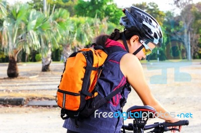 Young Woman Checking Mountain Bike Stock Photo