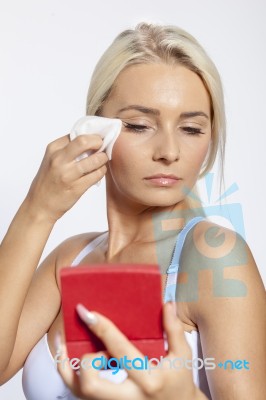 Young Woman Clean Face With Wet Wipes, Looking On Mirror In Hand… Stock Photo