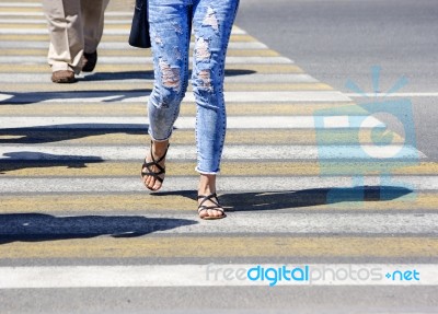 Young Woman Crossing A Street In The City Stock Photo