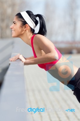 Young Woman Doing Push-ups Stock Photo