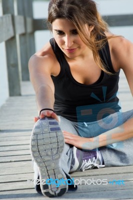 Young Woman Doing Push Ups Near The Sea Stock Photo