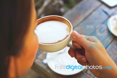 Young Woman Drinking Coffee Stock Photo