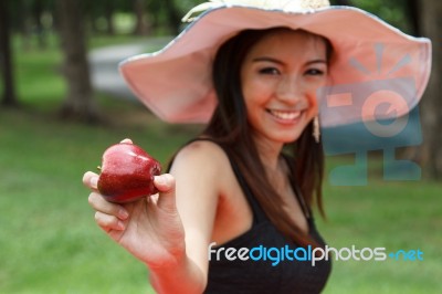 Young Woman Eating An Apple Stock Photo