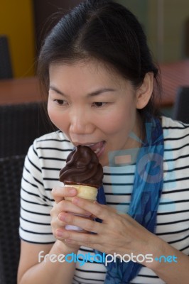 Young Woman Eating Ice Cream Stock Photo