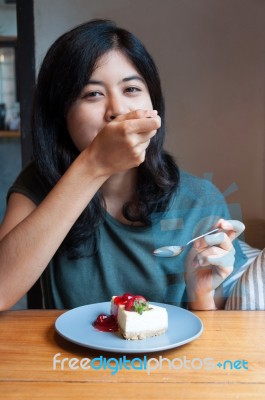 Young Woman Enjoy With A Cake In Cafe Stock Photo