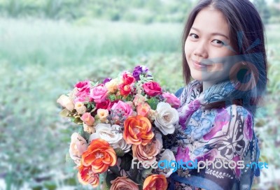 Young Woman Holding Artificial Flower Bouquet Stock Photo