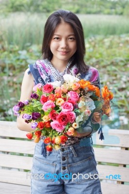 Young Woman Holding Bouquet Of Flower Stock Photo