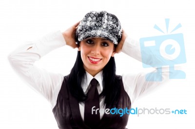 Young Woman In Cap Posing With Her Arms At Back Of Head Stock Photo