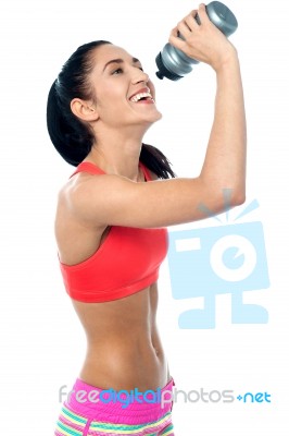 Young Woman In Gym Holding Sipper Bottle Stock Photo