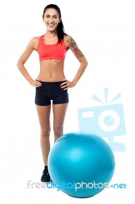 Young Woman In Gym Wear With Exercise Ball Stock Photo