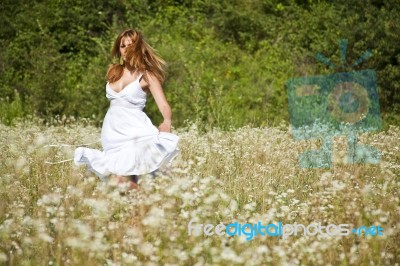 young Woman In Meadow Stock Photo