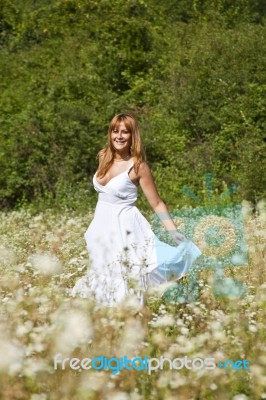 young Woman In Meadow Stock Photo