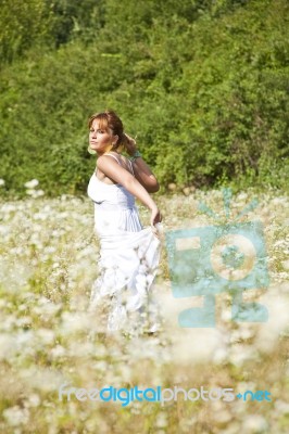 Young Woman In Meadow Stock Photo