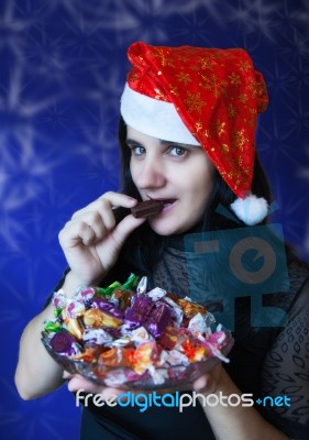 Young Woman In Santa Hat With Candy Stock Photo