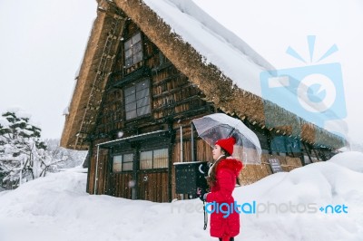 Young Woman In Shirakawa-go Village In Winter, Unesco World Heritage Sites, Japan Stock Photo