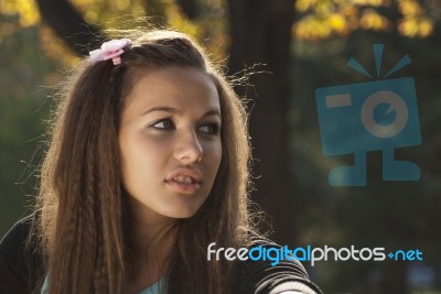 Young Woman In The Park Stock Photo