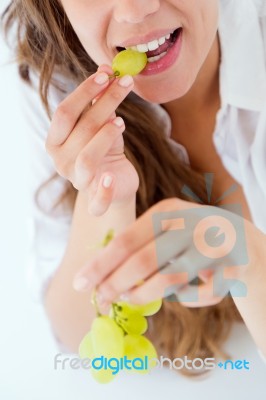 Young Woman In Underwear Eating Grapes. Isolated On White Stock Photo