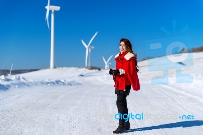 Young Woman Is A Happiness With Camera In Winter Of Sky And Winter Road With Snow And Red Dress Stock Photo