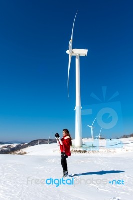 Young Woman Is A Happiness With Camera In Winter Of Sky And Winter Road With Snow And Red Dress Stock Photo