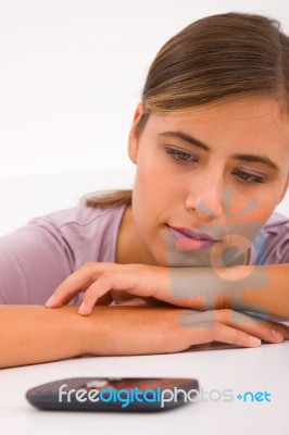 Young Woman Leaning Forward Desk Looking Cellphone Stock Photo