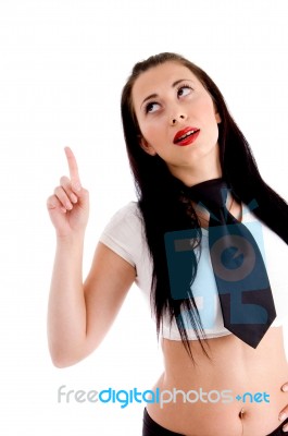 Young Woman Looking And Pointing Upwards Stock Photo