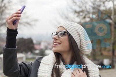 Young Woman Looking At Mobile Phone Stock Photo