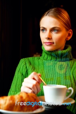 Young Woman Making Breakfast With A Cup Of Cappuccino And Croiss… Stock Photo