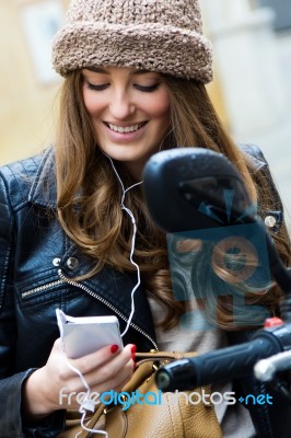 Young Woman Over A Motorcycle On The Street With His Mobile Phon… Stock Photo