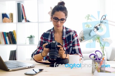 Young Woman Photographer Checking Previews On Camera In The Stud… Stock Photo